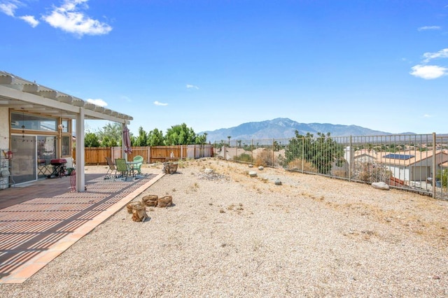 view of yard with a patio and a mountain view