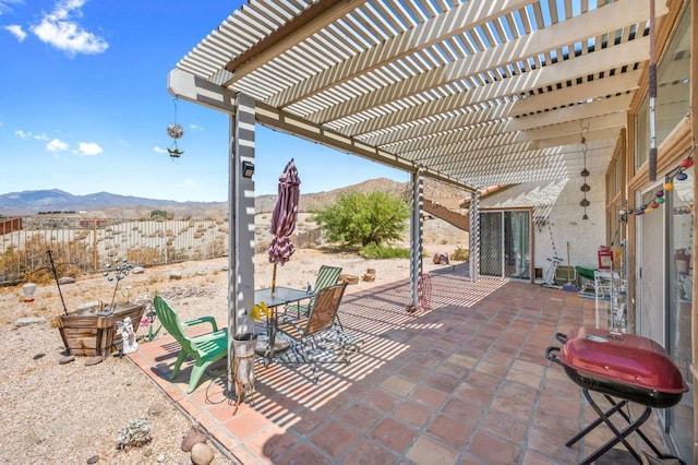 view of patio with a mountain view, a grill, and a pergola