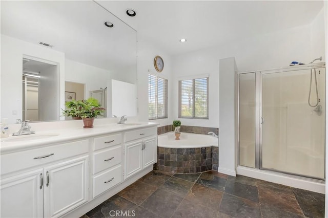 bathroom with stone tile floors, a sink, visible vents, a shower stall, and a bath