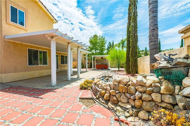 view of patio featuring a pergola and a jacuzzi