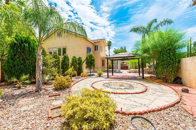 exterior space with a patio area, a fenced backyard, a gazebo, and stucco siding