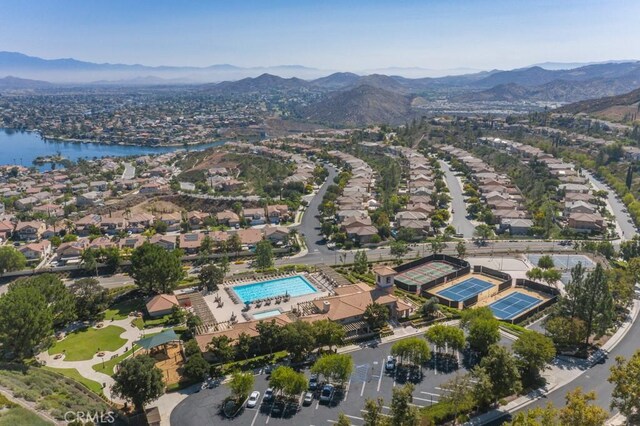 birds eye view of property with a water and mountain view