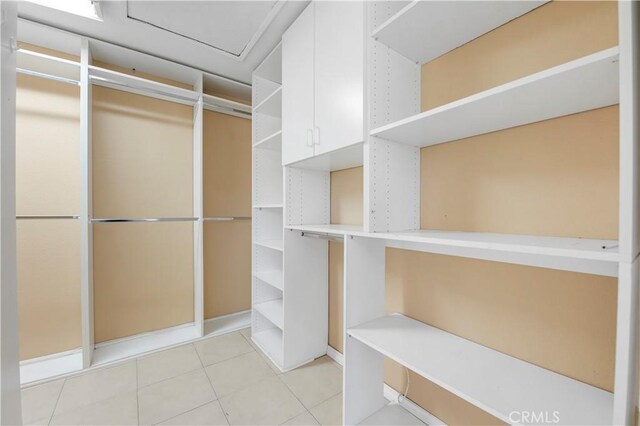 spacious closet featuring light tile patterned flooring