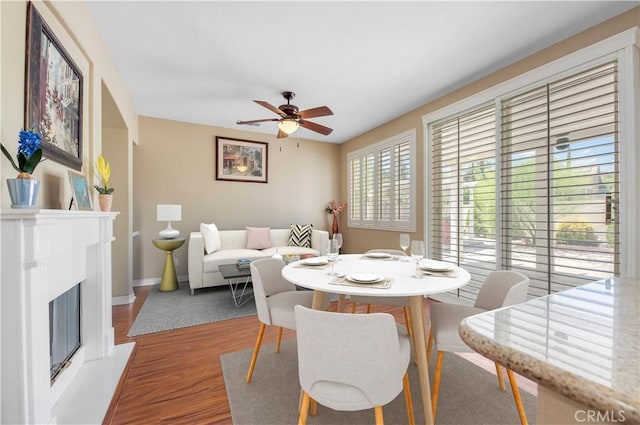 dining space with ceiling fan and hardwood / wood-style floors