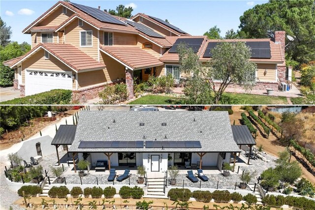 view of front of property with a garage and solar panels