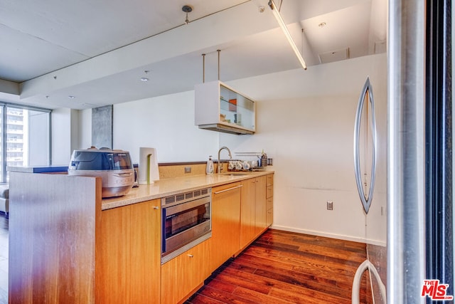 kitchen with sink, dark wood-type flooring, and stainless steel appliances