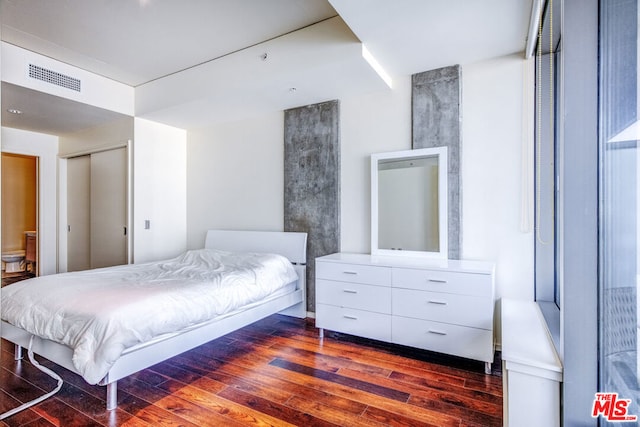 bedroom with hardwood / wood-style flooring and a closet