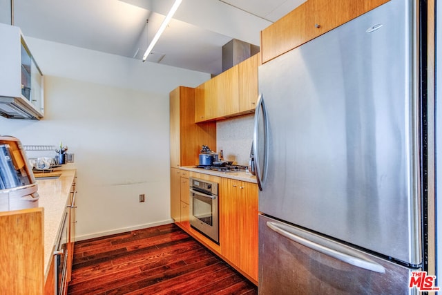 kitchen with dark wood-type flooring and stainless steel appliances