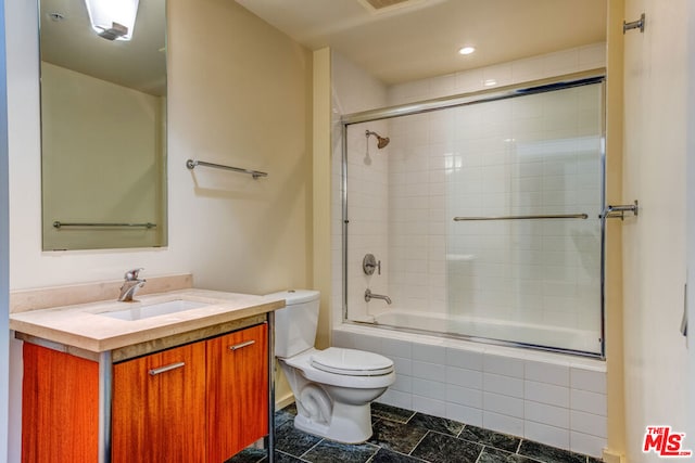 full bathroom featuring tile patterned floors, vanity, shower / bath combination with glass door, and toilet