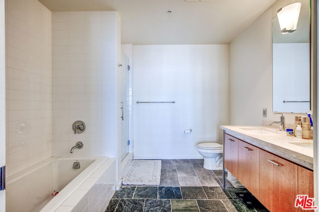 full bathroom featuring toilet, tiled shower / bath combo, double sink vanity, and tile patterned floors