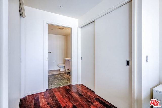 hall with hardwood / wood-style floors