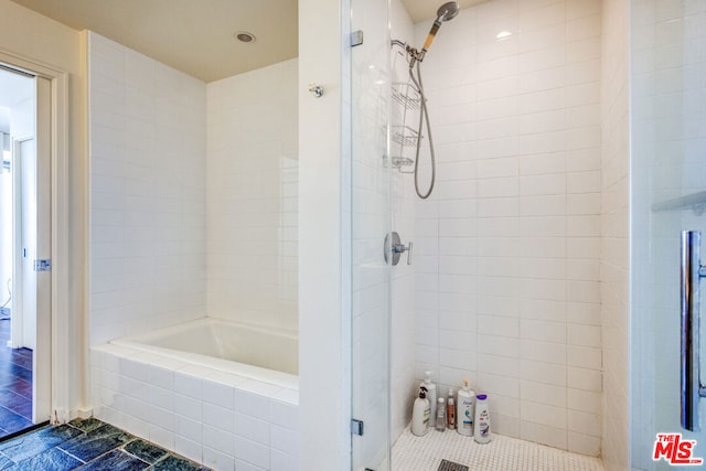 bathroom with tile patterned flooring and tiled shower / bath