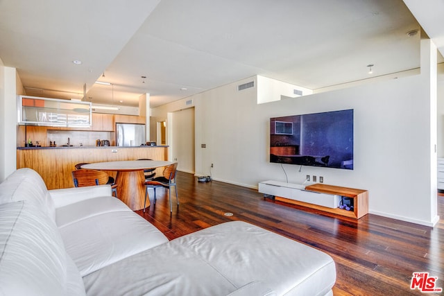 living room with dark hardwood / wood-style flooring