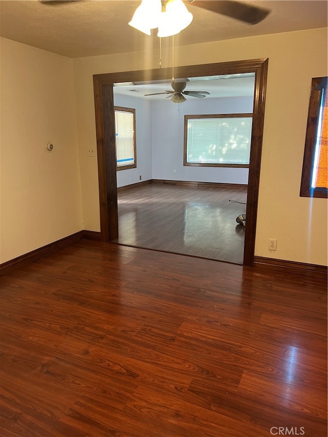 spare room with ceiling fan, dark hardwood / wood-style floors, and a textured ceiling