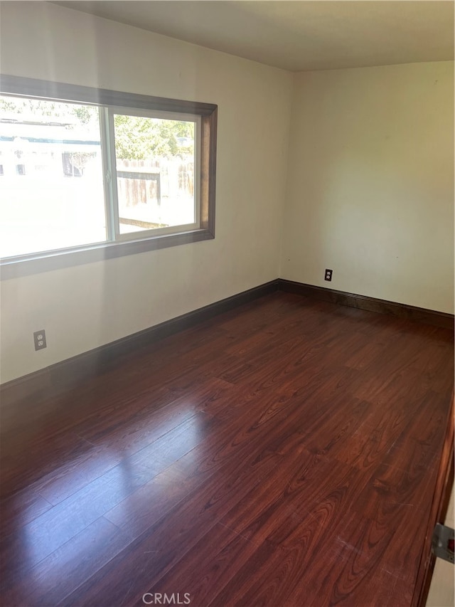 spare room featuring dark hardwood / wood-style flooring