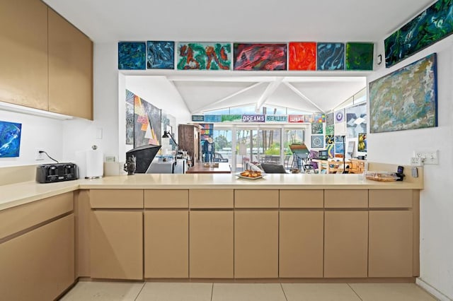 kitchen with light tile patterned floors and vaulted ceiling