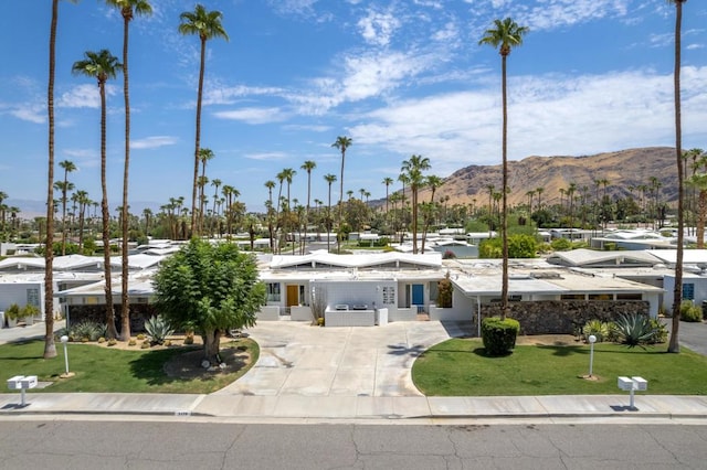 exterior space with a mountain view and a lawn