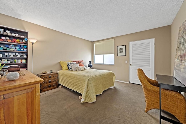 bedroom with dark carpet and a textured ceiling