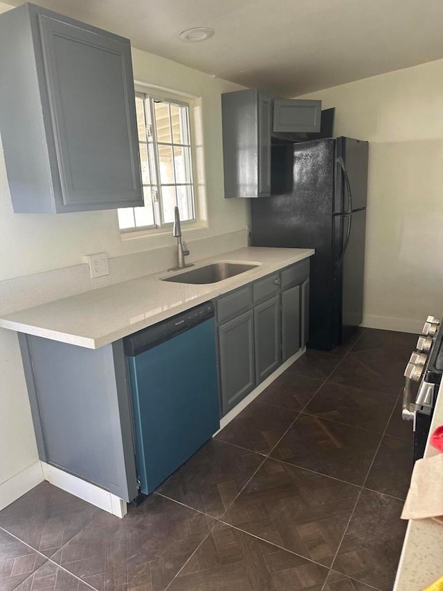 kitchen with stainless steel appliances, sink, and gray cabinetry