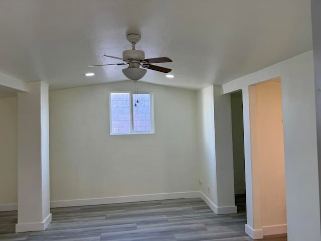 unfurnished room featuring ceiling fan, vaulted ceiling, and light hardwood / wood-style floors