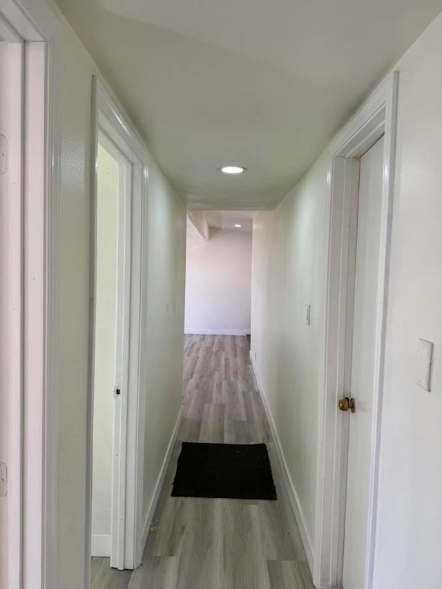 corridor with light hardwood / wood-style flooring