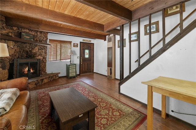 entryway featuring beam ceiling, a fireplace, dark wood-type flooring, and wood ceiling