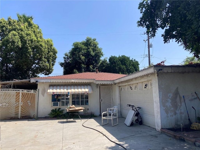 exterior space with a garage and a patio area