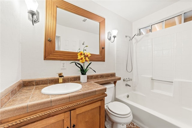 full bathroom with tiled shower / bath combo, vanity, and toilet