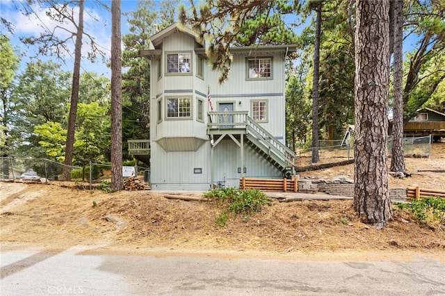 view of front of house featuring stairs and fence