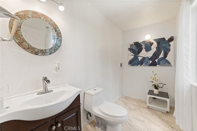 bathroom featuring toilet, lofted ceiling, and vanity