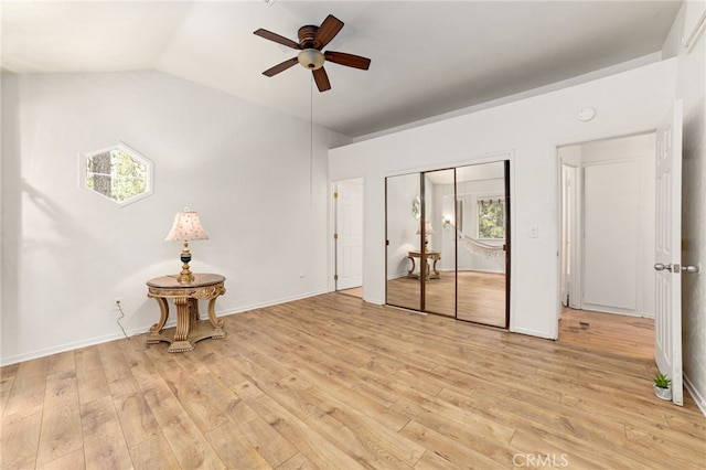 interior space featuring ceiling fan, lofted ceiling, plenty of natural light, and light hardwood / wood-style floors