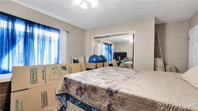 bedroom featuring a textured ceiling and a closet