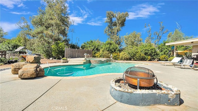 view of pool featuring an in ground hot tub, a patio, and an outdoor fire pit