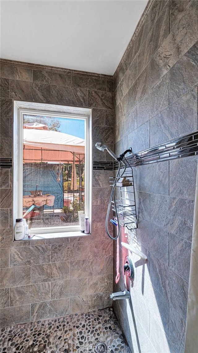 interior details featuring tiled shower