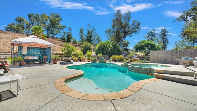 view of swimming pool featuring a gazebo, an in ground hot tub, and a patio