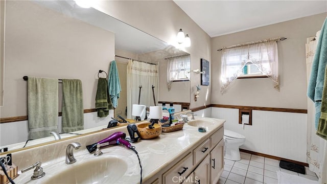 bathroom featuring vanity, wood walls, tile patterned floors, toilet, and walk in shower