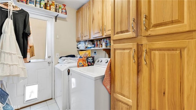 washroom with cabinets, light tile patterned flooring, and washing machine and clothes dryer