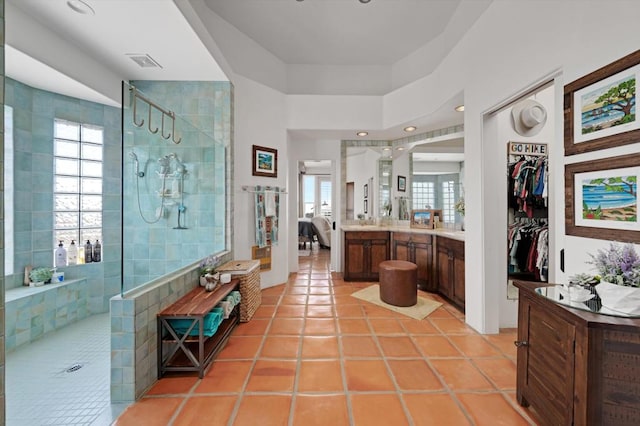 bathroom with vanity, tile patterned floors, and tiled shower