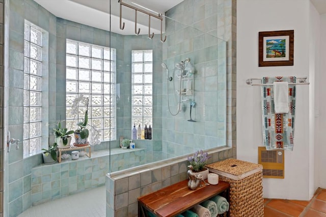 bathroom featuring tile patterned floors and tiled shower