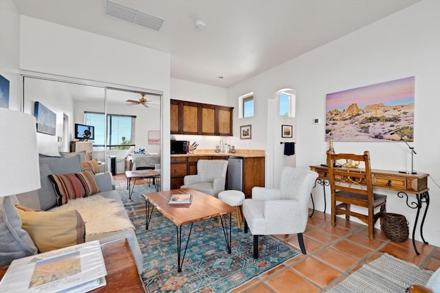 tiled living room featuring ceiling fan