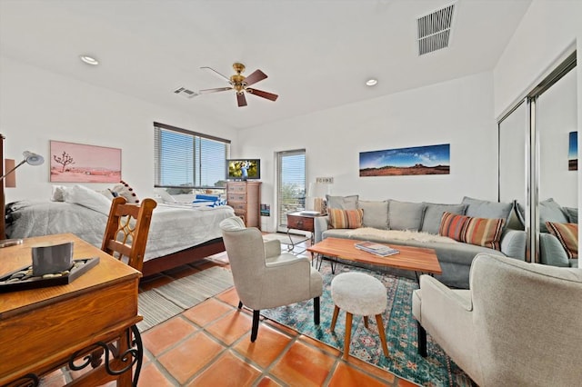 tiled bedroom featuring ceiling fan