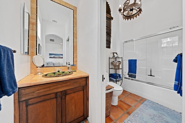 full bathroom with vanity, combined bath / shower with glass door, toilet, and tile patterned floors