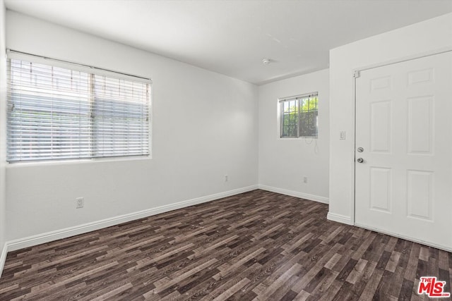 spare room with dark wood-type flooring