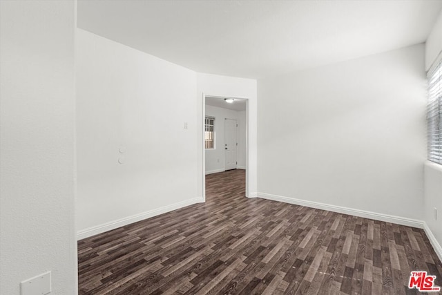 empty room with dark hardwood / wood-style floors