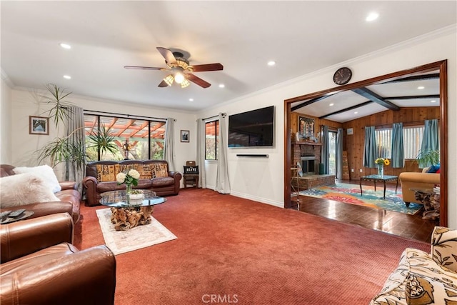 carpeted living room featuring vaulted ceiling with beams, ceiling fan, and crown molding