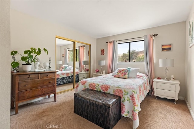 bedroom featuring light carpet and a closet