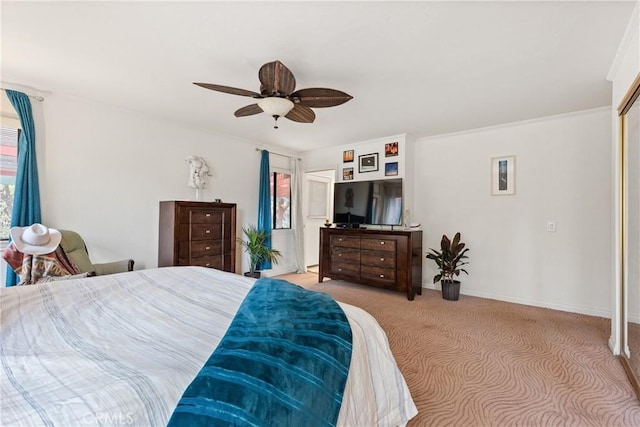 carpeted bedroom featuring ceiling fan and ornamental molding