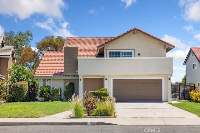 mediterranean / spanish house with a garage and a front lawn