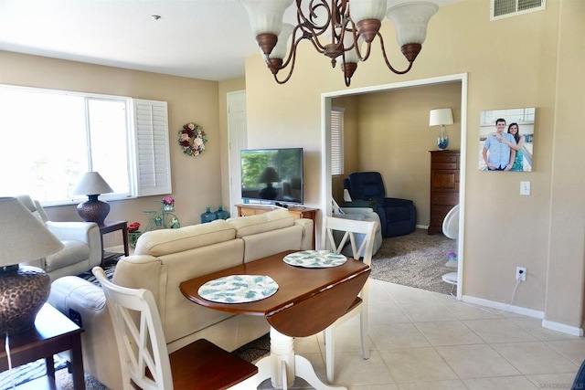 dining room with light tile patterned flooring and a chandelier