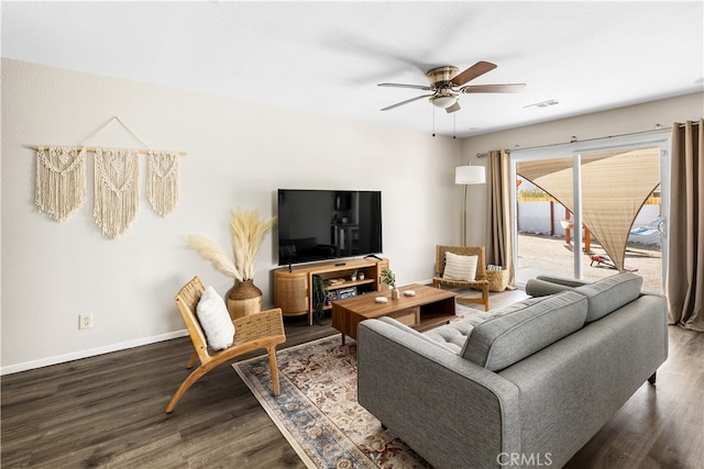 living room with ceiling fan and dark hardwood / wood-style floors